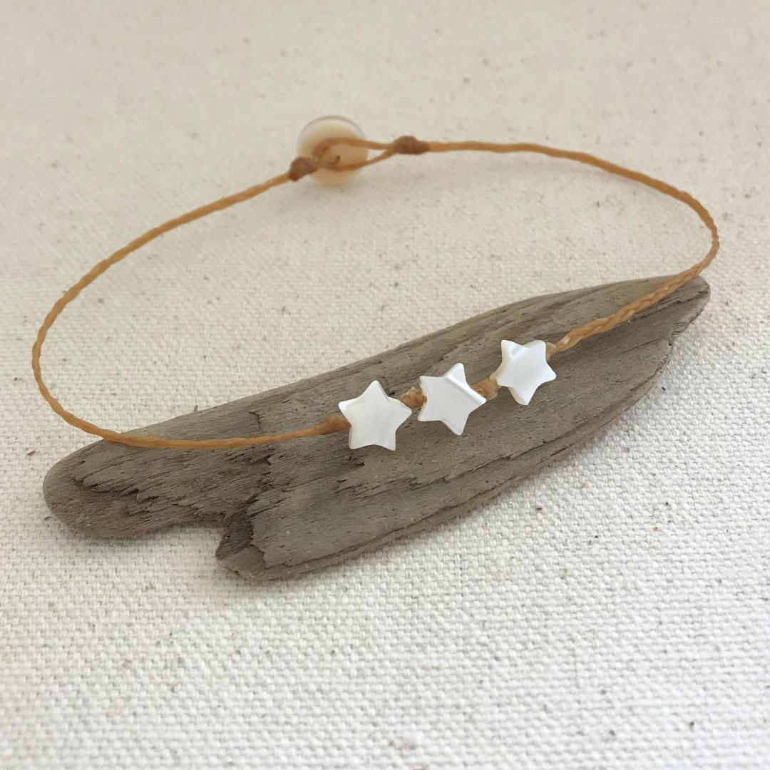 beach boho style anklet with three 7mm mother of pearl stars knotted onto braided waxed cord