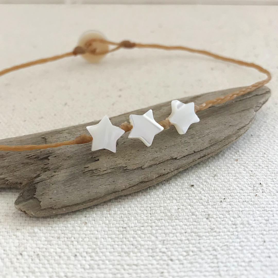 beach boho style anklet with three 7mm mother of pearl stars knotted onto braided waxed cord