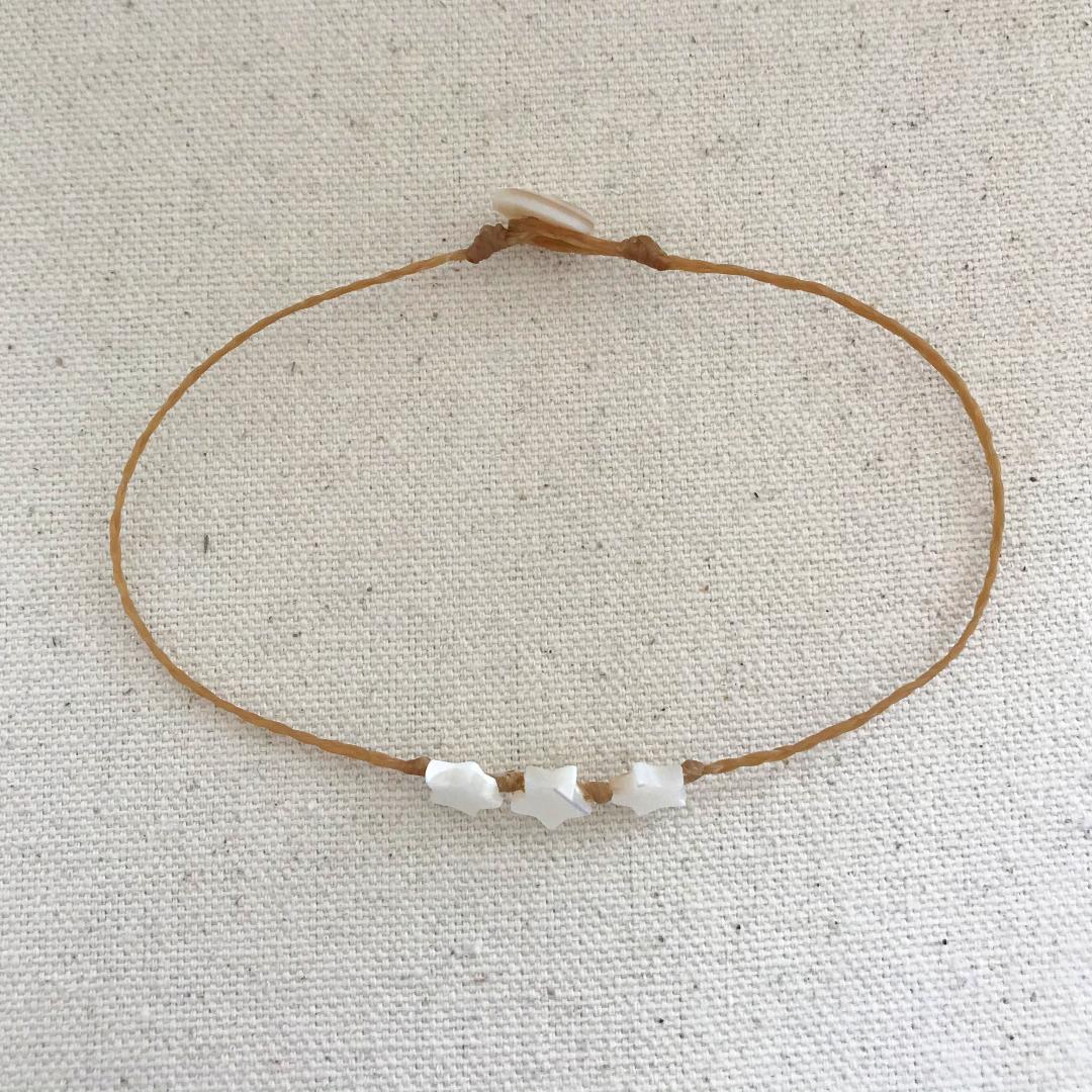 beach boho style anklet with three 7mm mother of pearl stars knotted onto braided waxed cord