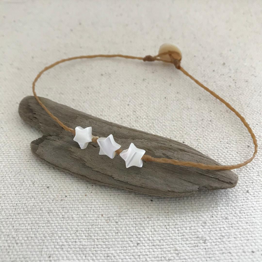 beach boho style anklet with three 7mm mother of pearl stars knotted onto braided waxed cord